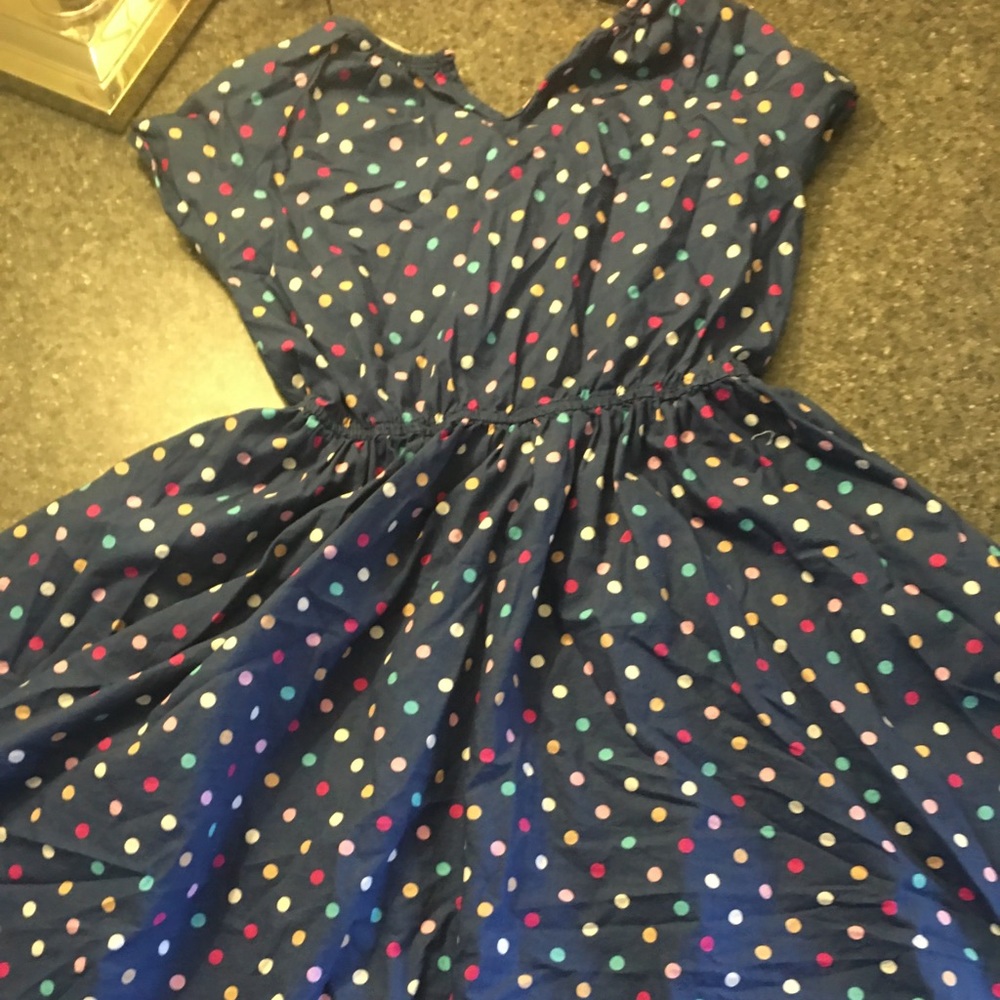 Navy blue dres with colorful polka dots.